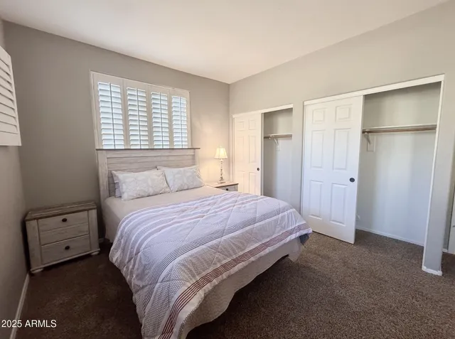 a bedroom with a bed and a closet