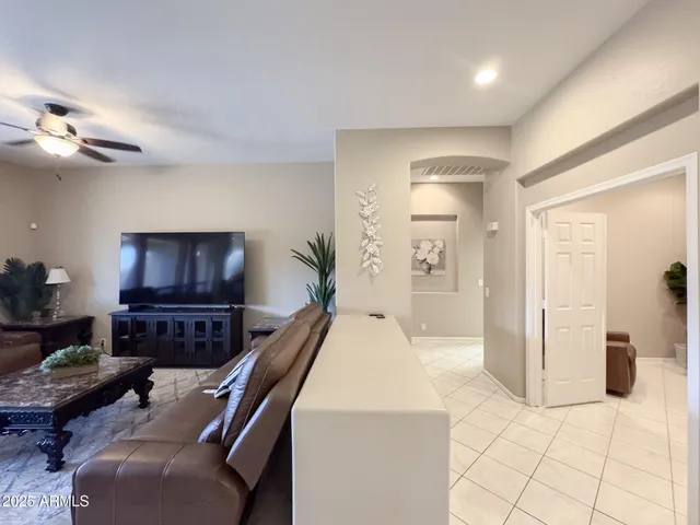 a living room with furniture and a chandelier