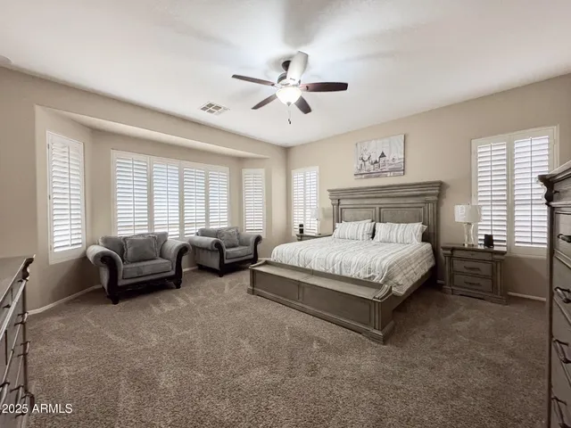 a spacious bedroom with a bed and furniture