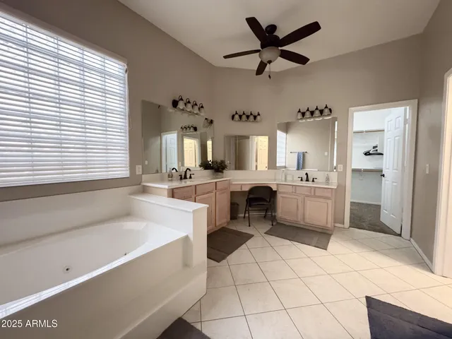 a large white kitchen with a window and kitchen view