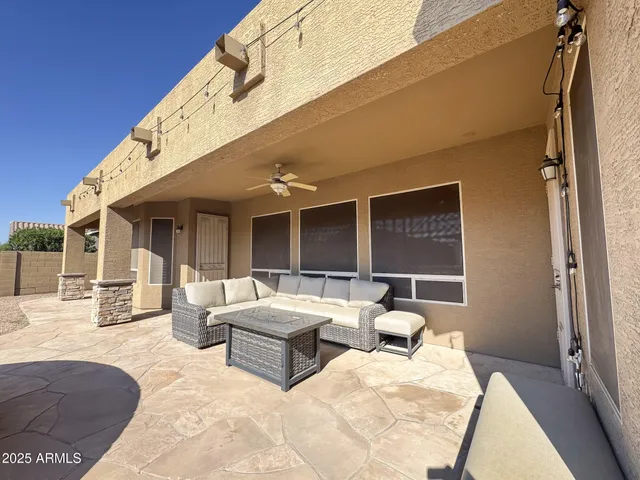 a view of a patio with dining table and chairs with wooden floor and fence