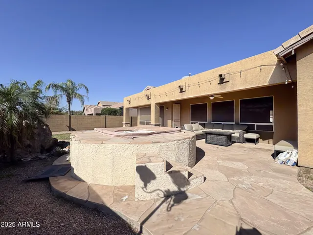 a view of a patio with table and chairs with wooden floor and plants