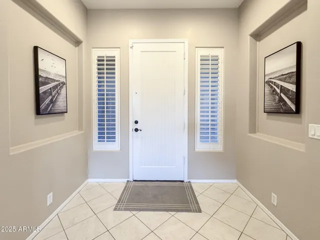 a view of an empty room with window and cabinet