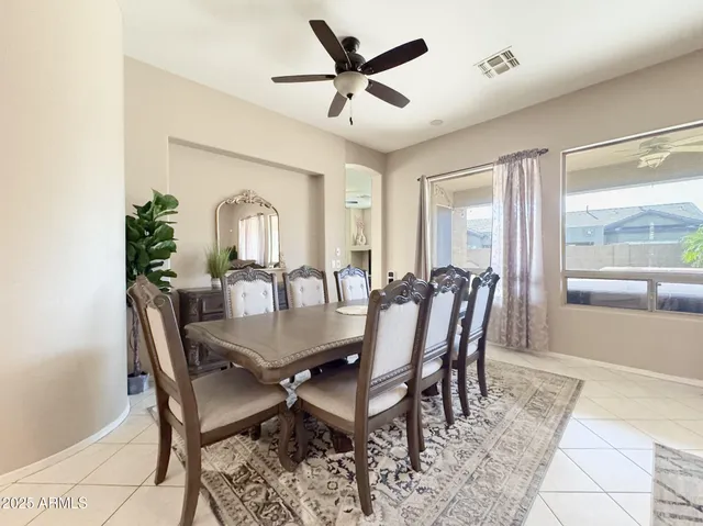 a view of a dining room with furniture and a large window