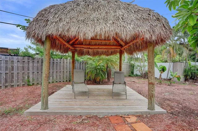 a view of a backyard with wooden fence