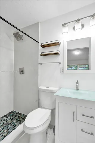 a bathroom with a sink a toilet and a mirror