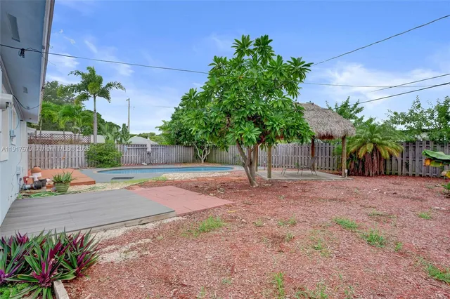 a view of a yard with potted plants