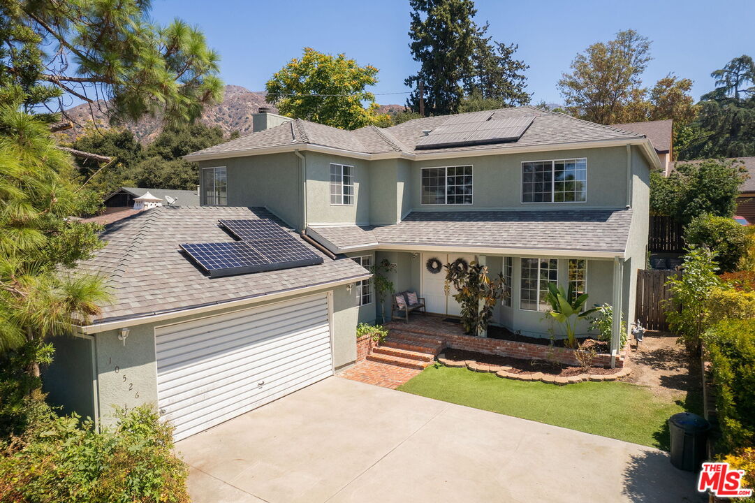 10526 Samoa Avenue Tujunga, CA 91042 - Photo 2 of 7 a front view of a house with garden
