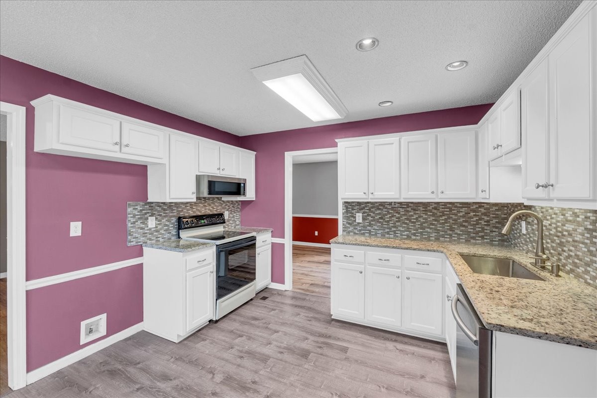99 Arrowhead Drive Manchester, TN 37355 - Photo 11 of 39 a kitchen with granite countertop a sink and a stove top oven