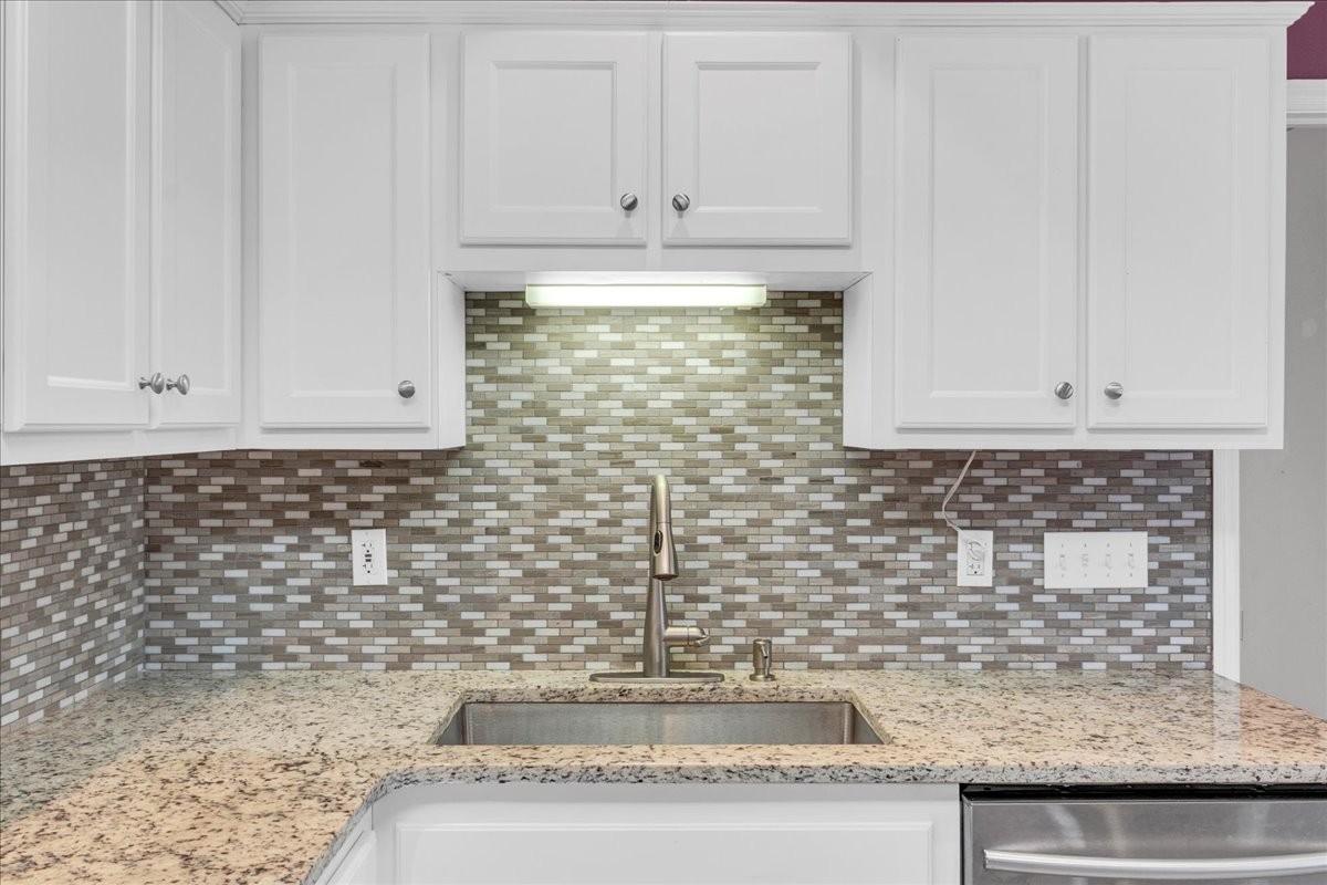 99 Arrowhead Drive Manchester, TN 37355 - Photo 16 of 39 a kitchen with granite countertop white cabinets and a sink