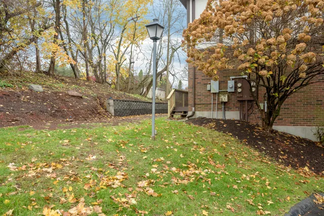 a front view of a house with a yard and outdoor seating