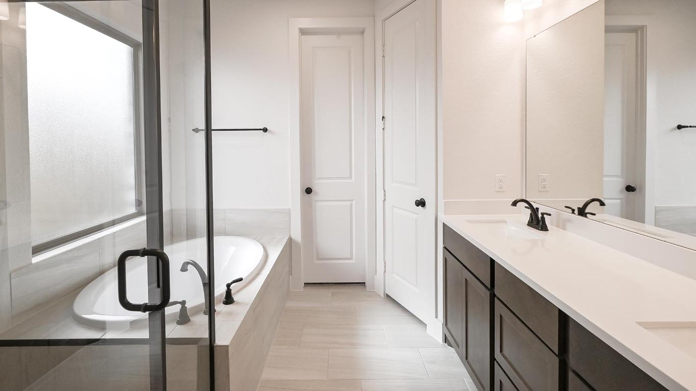 580 Bay Breeze Drive Kyle, TX 78640 - Photo 11 of 35 a bathroom with a sink a mirror and a shower