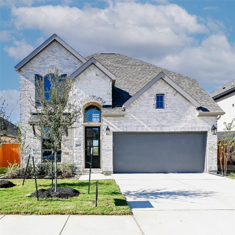 580 Bay Breeze Drive Kyle, TX 78640 - Photo 2 of 35 a front view of a house with a yard and garage