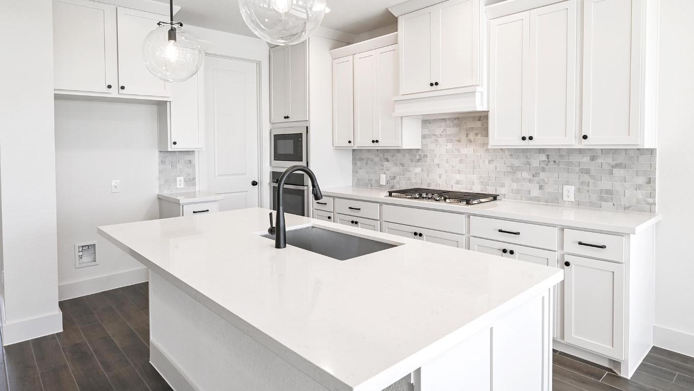 580 Bay Breeze Drive Kyle, TX 78640 - Photo 8 of 35 a kitchen with white cabinets and white appliances