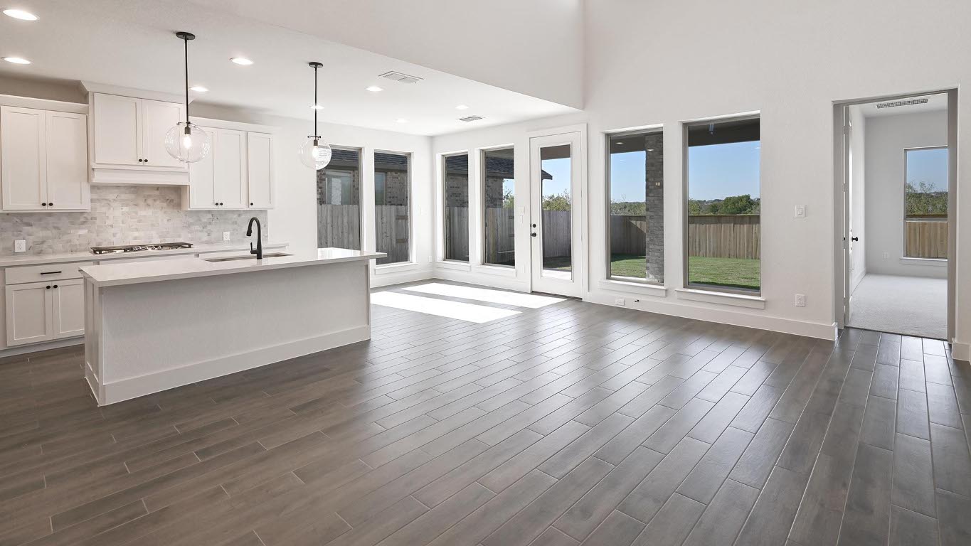 580 Bay Breeze Drive Kyle, TX 78640 - Photo 9 of 35 a view of a kitchen with wooden floor and a window