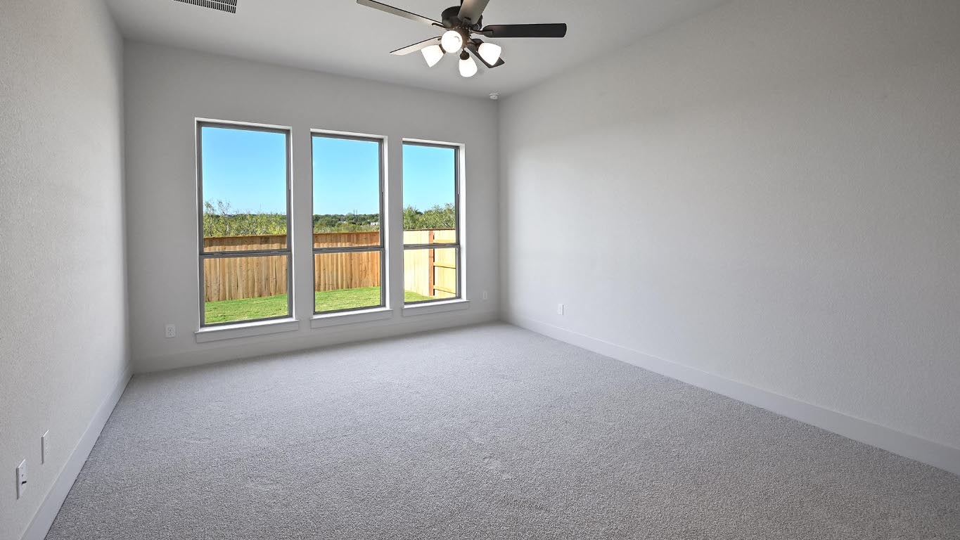 580 Bay Breeze Drive Kyle, TX 78640 - Photo 10 of 35 a view of a livingroom with a ceiling fan and window