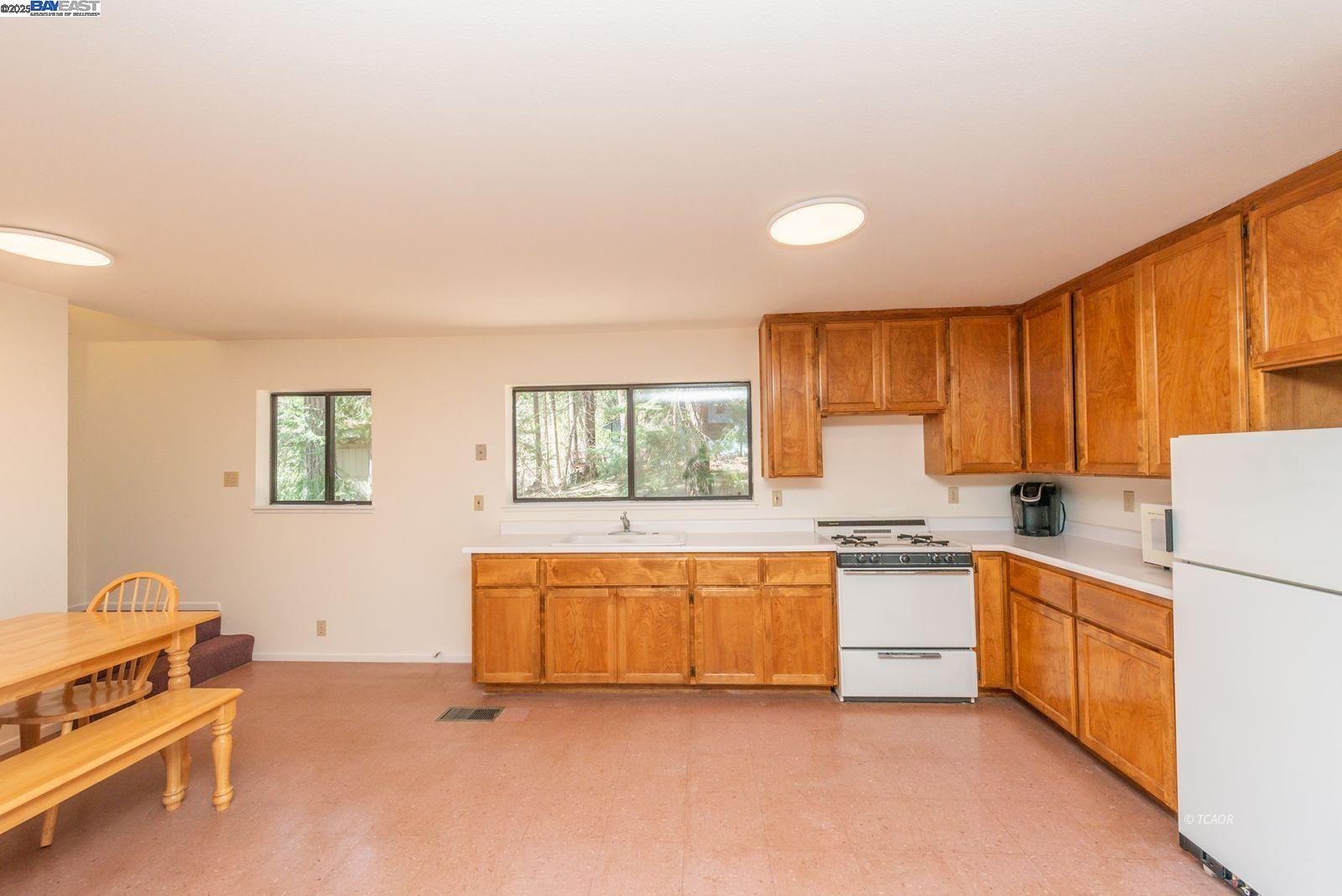 121 Mountain Aire Lane Trinity Center, CA 96091 - Photo 13 of 51 a kitchen with stainless steel appliances granite countertop a stove a sink and a refrigerator