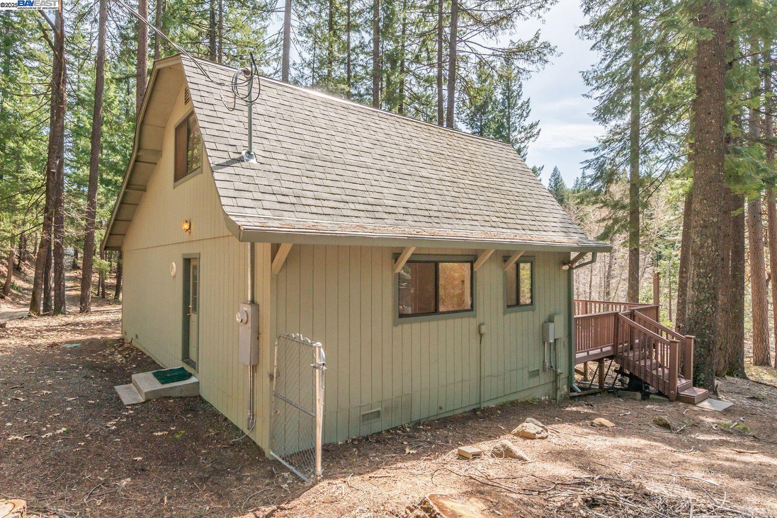 121 Mountain Aire Lane Trinity Center, CA 96091 - Photo 47 of 51 a view of a wooden house with a large tree and wooden fence