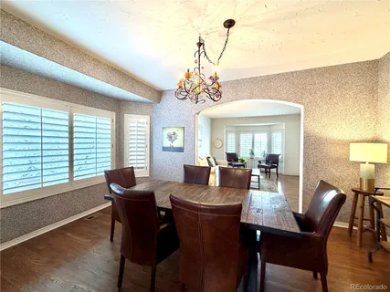 a living room with furniture a fireplace and wooden floor