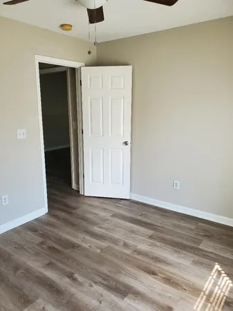 a view of an empty room with wooden floor