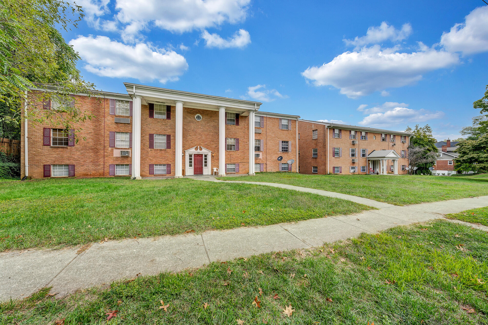 1711 Westover Avenue Southwest, Unit 12 Roanoke, VA 24015 - Photo 1 of 10 a view of a house with a big yard and large trees