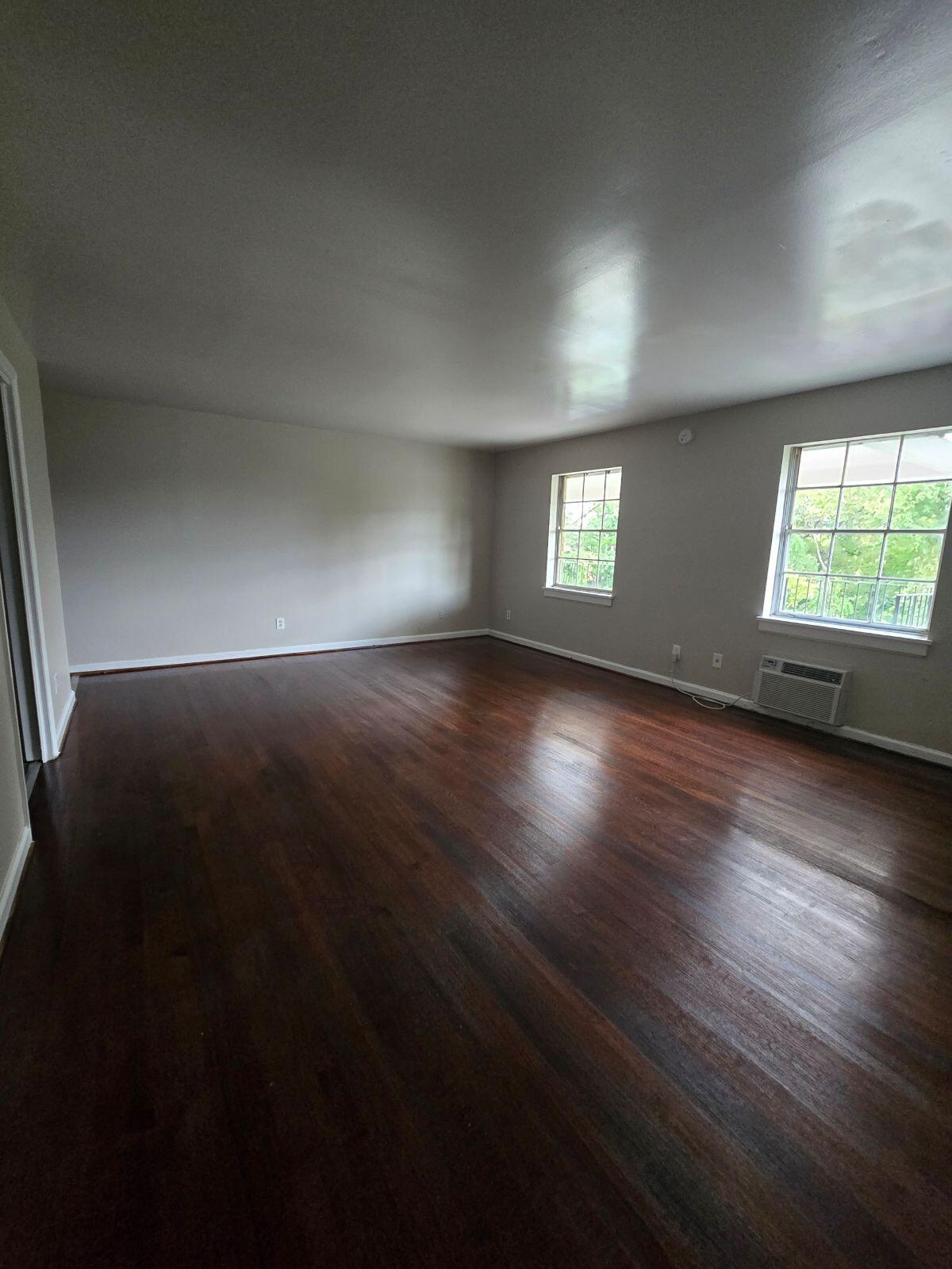 1711 Westover Avenue Southwest, Unit 12 Roanoke, VA 24015 - Photo 8 of 10 an empty room with wooden floor and windows