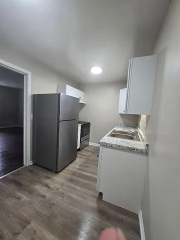 a kitchen with a refrigerator and a stove
