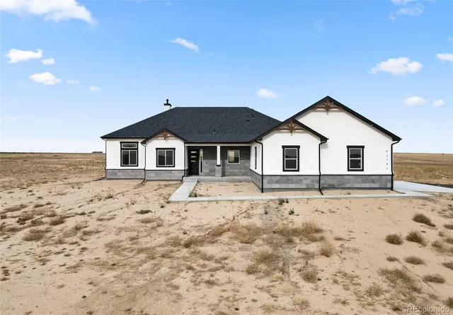 a view of white house with a yard