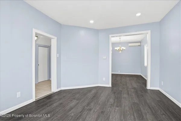 a kitchen with granite countertop a refrigerator stove and sink