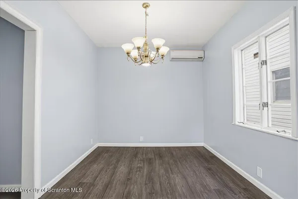 a kitchen with stainless steel appliances cabinets and wooden floor