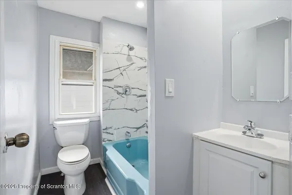 a view of a house with a small yard and wooden fence