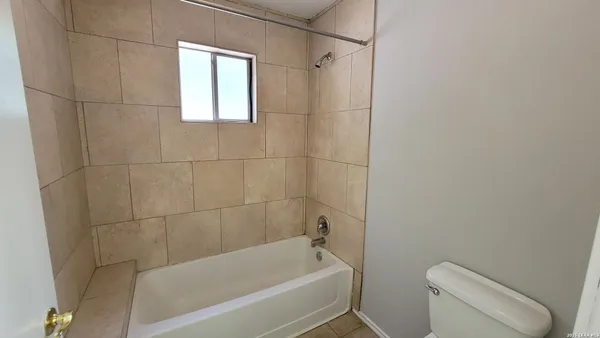 a bathroom with a bathtub and window