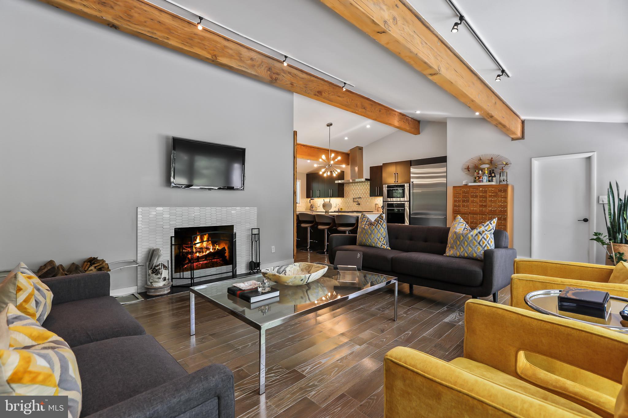 1004 Mercer Road Princeton, NJ 08540 - Photo 16 of 28 a living room with furniture a flat screen tv and a fireplace