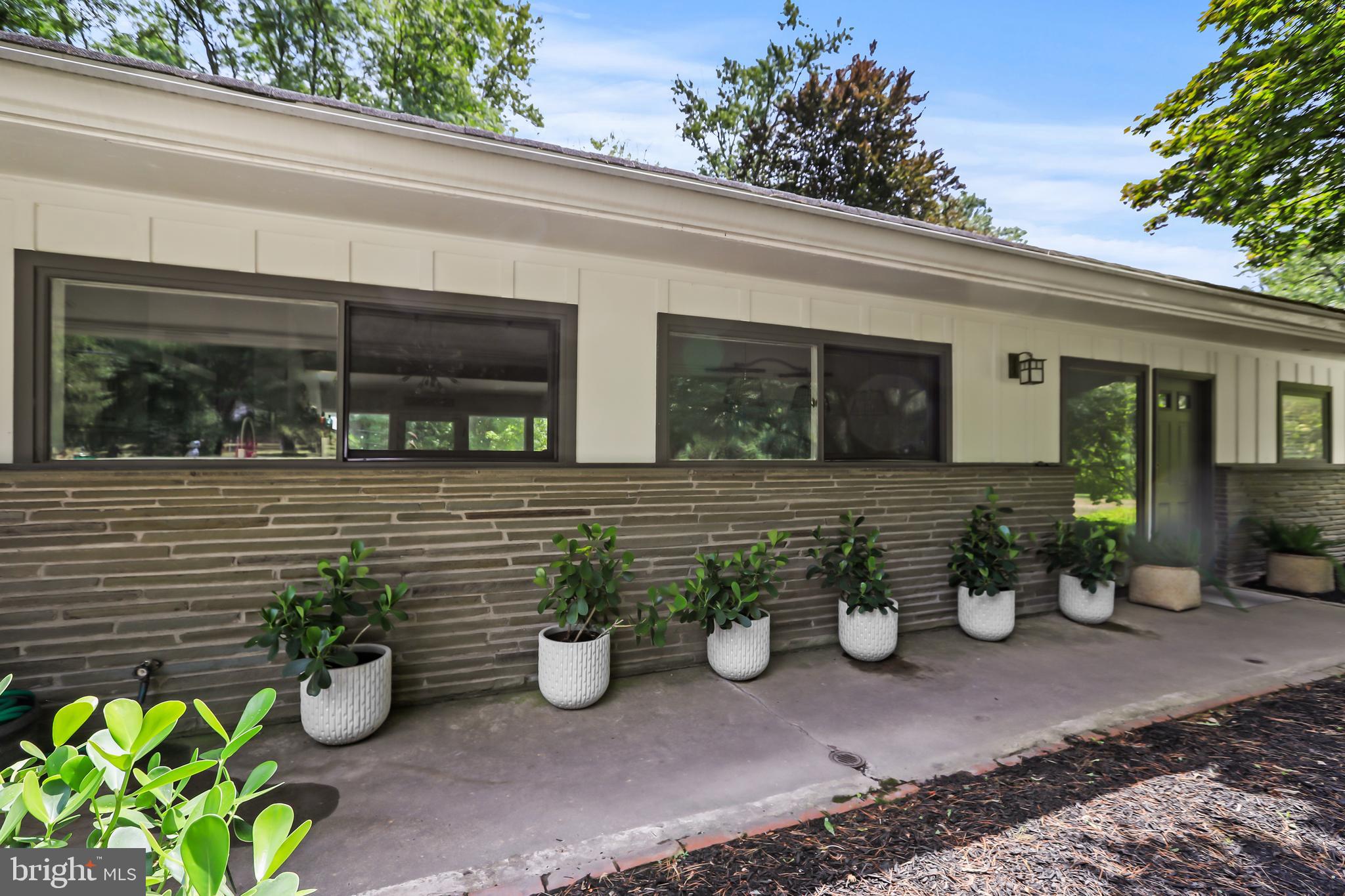 1004 Mercer Road Princeton, NJ 08540 - Photo 3 of 28 a view of a chair and potted plants