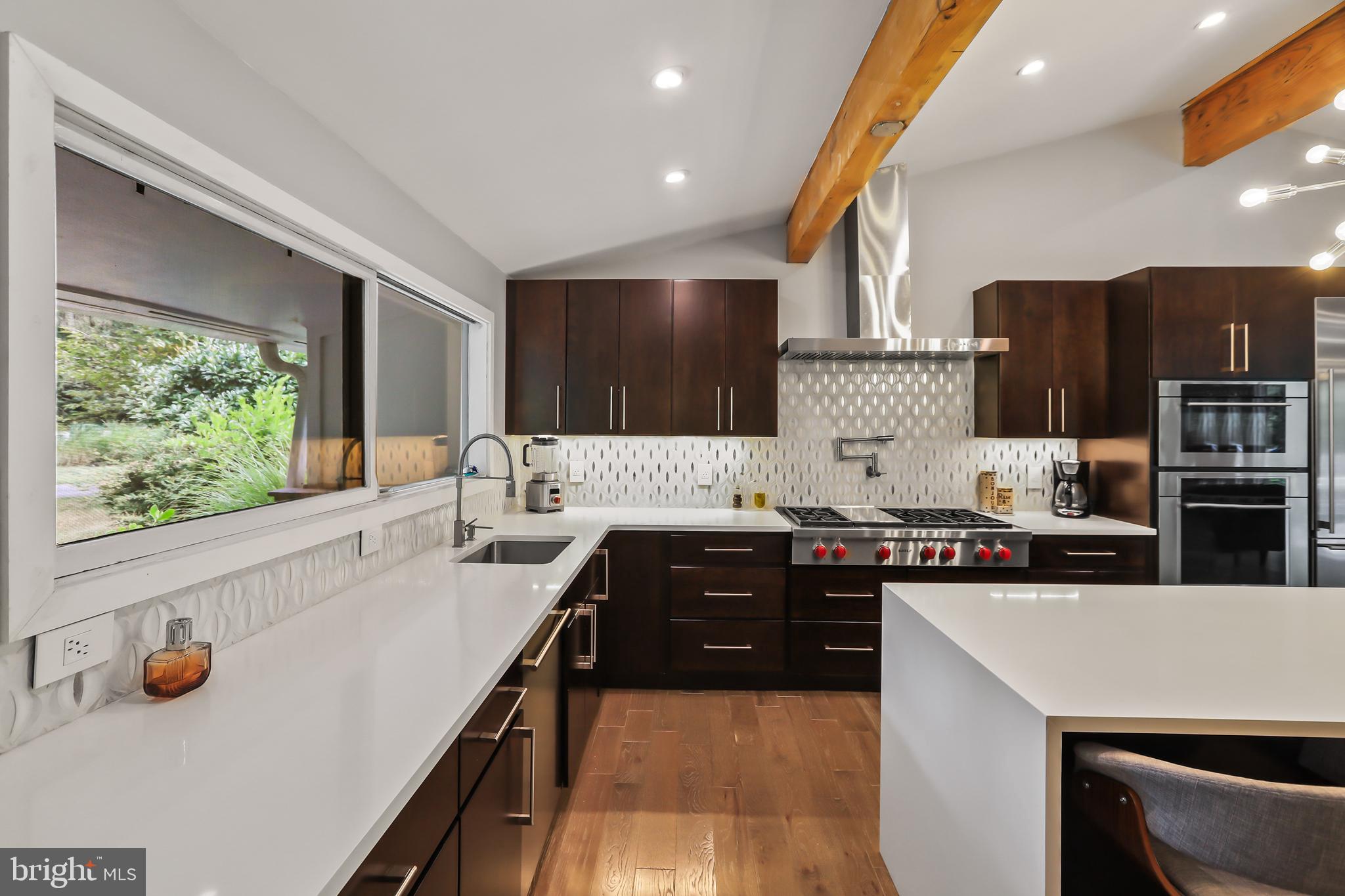1004 Mercer Road Princeton, NJ 08540 - Photo 7 of 28 a kitchen with stainless steel appliances a stove sink and cabinets