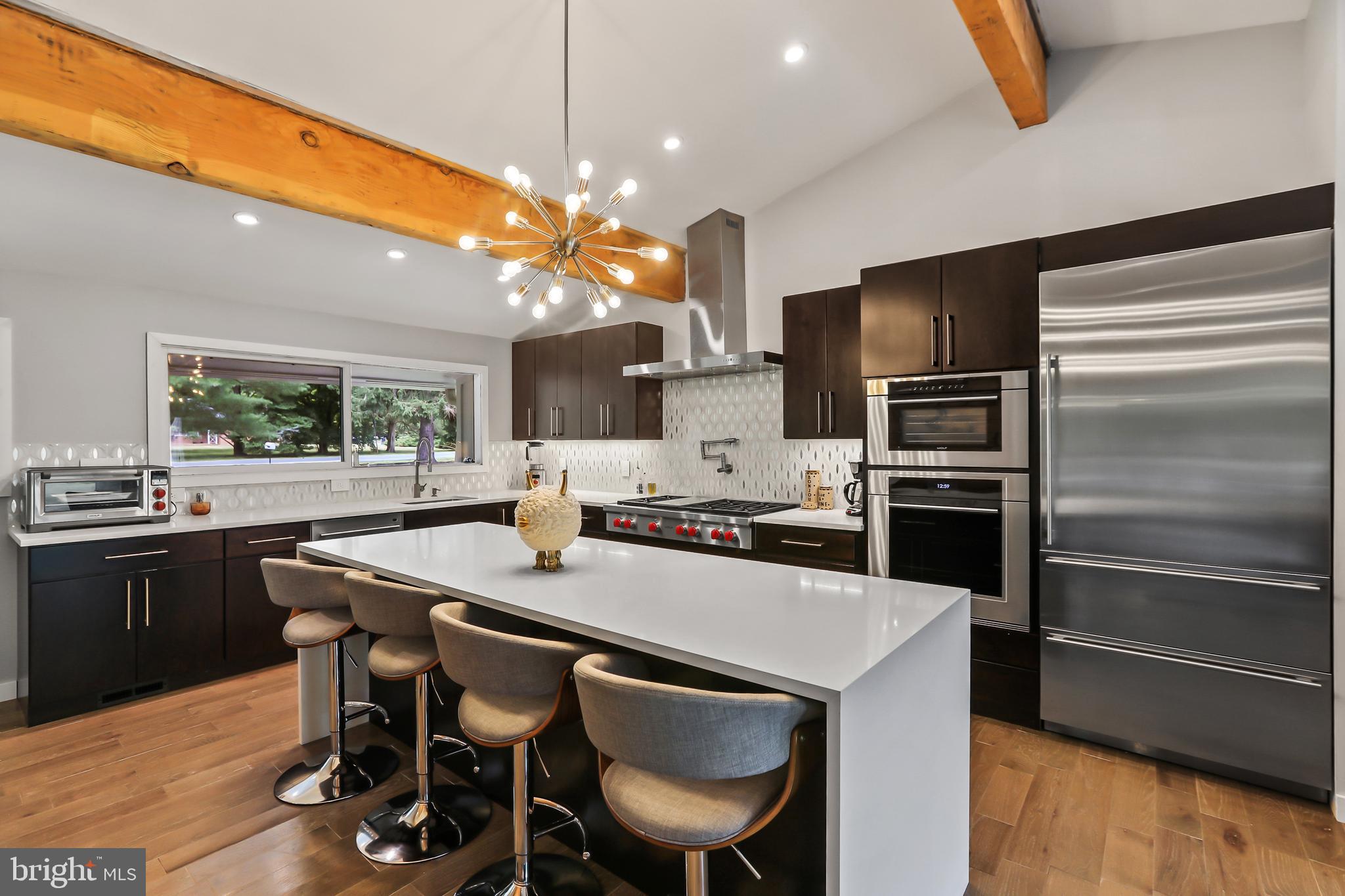 1004 Mercer Road Princeton, NJ 08540 - Photo 8 of 28 a kitchen with stainless steel appliances a table chairs and a refrigerator