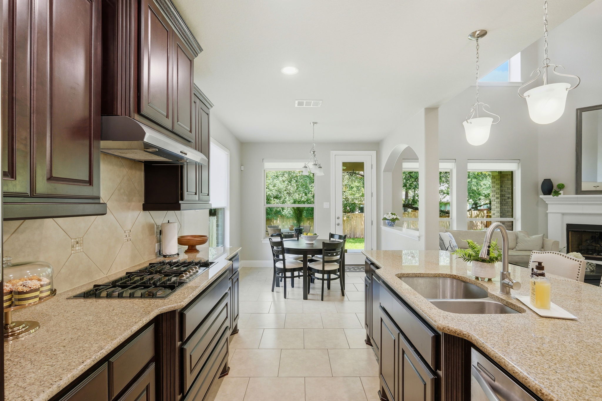 110 Dasher Drive Cedar Park, TX 78613 - Photo 11 of 39 A well-appointed kitchen features rich cabinetry, stone counters, and a central island, flowing into a bright eat-in area.