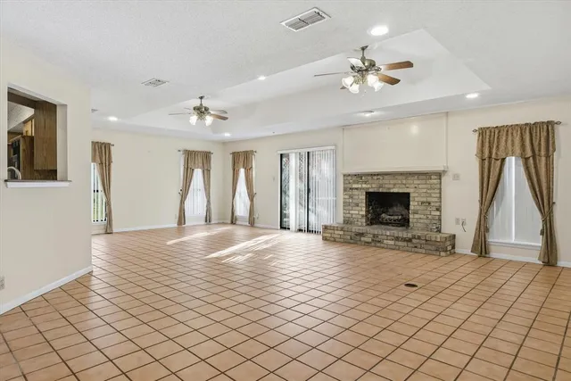 a kitchen with stainless steel appliances granite countertop a refrigerator a sink dishwasher a stove and white cabinets with wooden floor