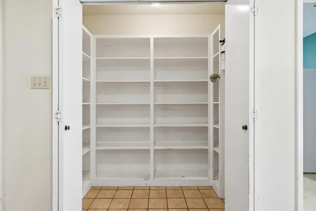 a room with a cabinet and a ceiling fan