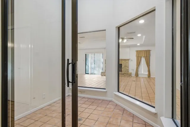 a bathroom with a granite countertop tub shower and mirror