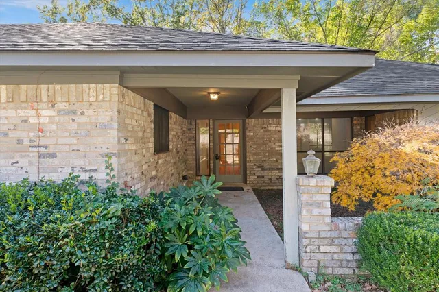 a view of a bedroom with a bed and a chandelier