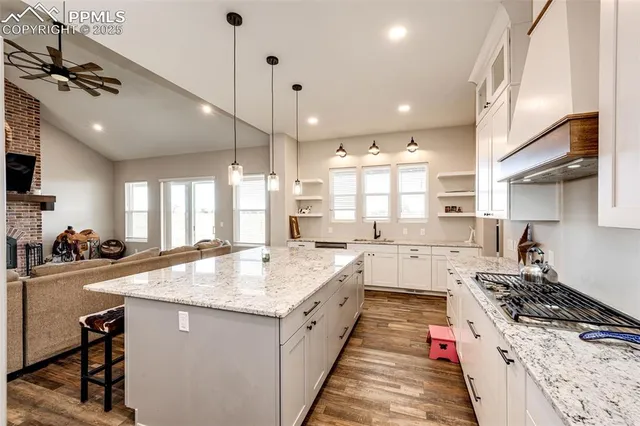 a kitchen with a stove sink and cabinets
