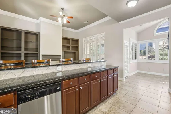 a kitchen with stainless steel appliances granite countertop a sink and a stove