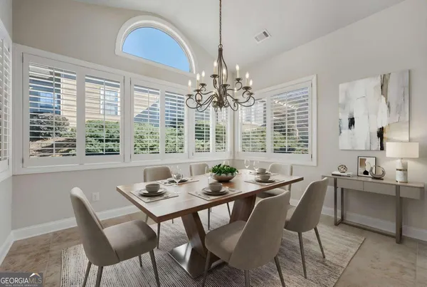 a dining room with furniture and window