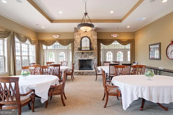 a living room with furniture a fireplace and a chandelier