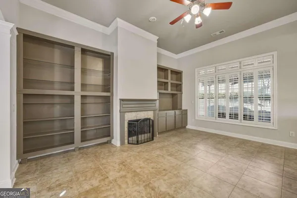 a view of an empty room with a fireplace and a window
