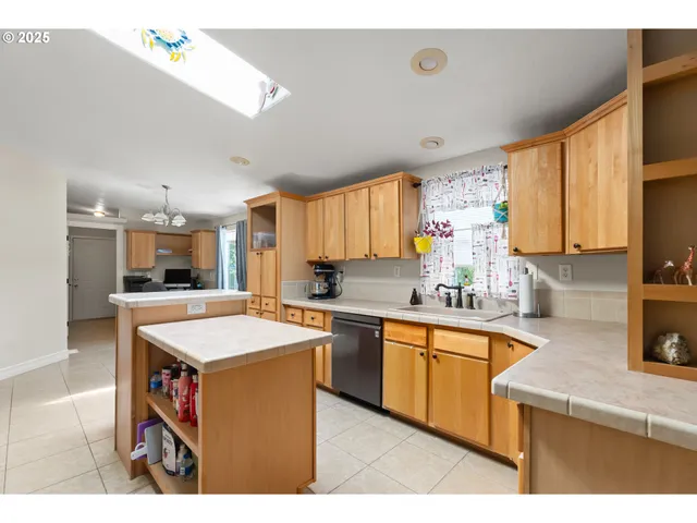 a kitchen with stainless steel appliances a stove top oven