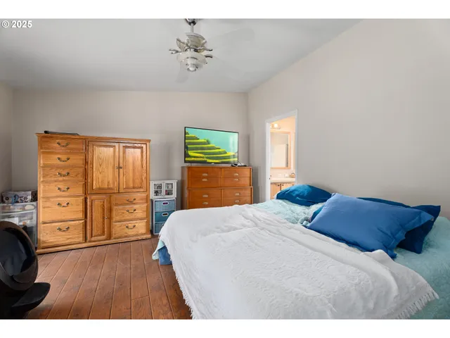 a bedroom with a large bed and a chandelier