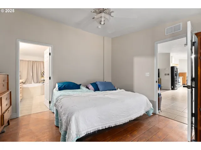 a bathroom with a double vanity sink a mirror and a bathtub