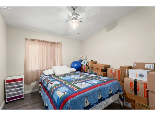 a bathroom with a granite countertop sink a toilet a mirror and shower